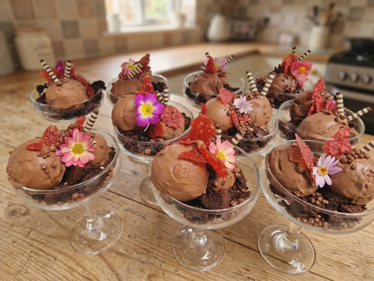 Individual chocolate desserts finished with edible flowers