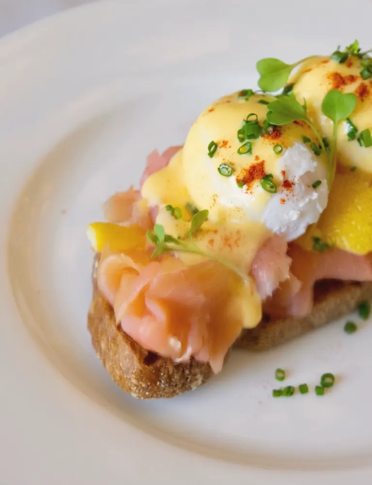A plated brunch dish with cured salmon and a poached egg