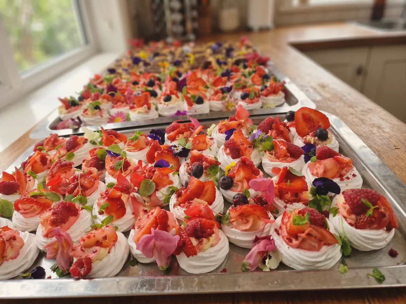 A tray of individual desserts plated for a large party